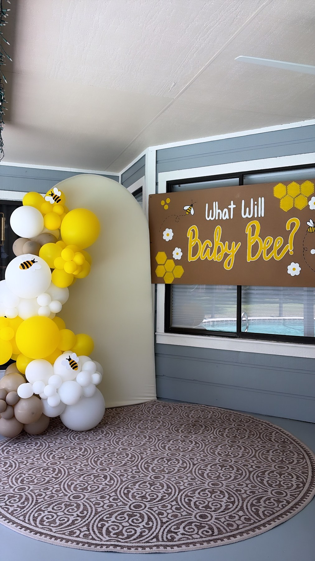 Hand-painted What Will Baby Bee banner at a baby shower